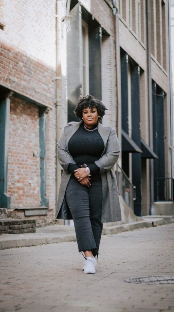 A image of a black woman wearing all black promoting sharing tips on planning a brand photoshoot.